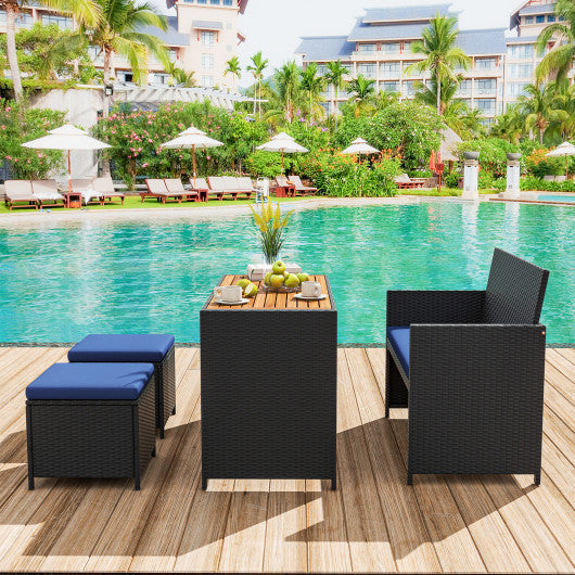 4 Piece Outdoor Dining Set with Wood Topped Dining Table  Rattan Loveseat Chair and 2 Ottomans-Navy